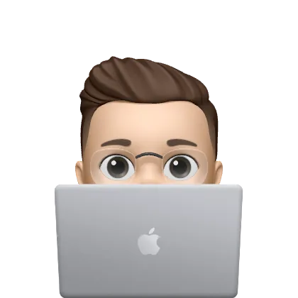 Memoji of Evan peeking over a laptop